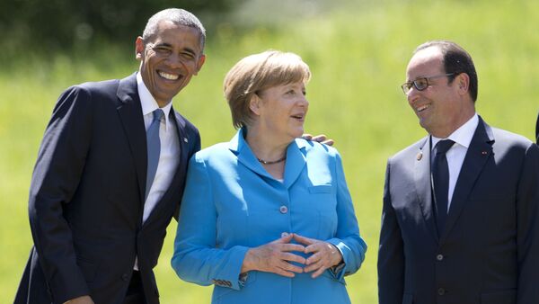 From left, US President Barack Obama, German Chancellor Angela Merkel, and French President Francois Hollande gather to pose for a group photo during the G-7 summit in Schloss Elmau hotel near Garmisch-Partenkirchen, southern Germany, Sunday, June 7, 2015 - Sputnik International