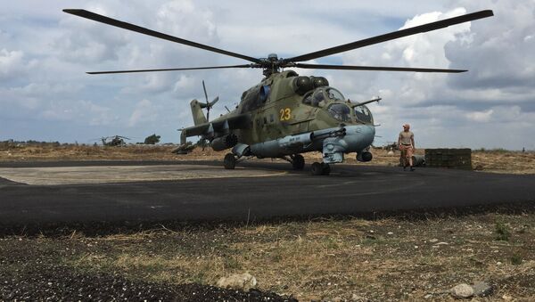 Ground crew servicing a Russian Mi-24 helicopter in Syria's Hmeymim airbase. - Sputnik International