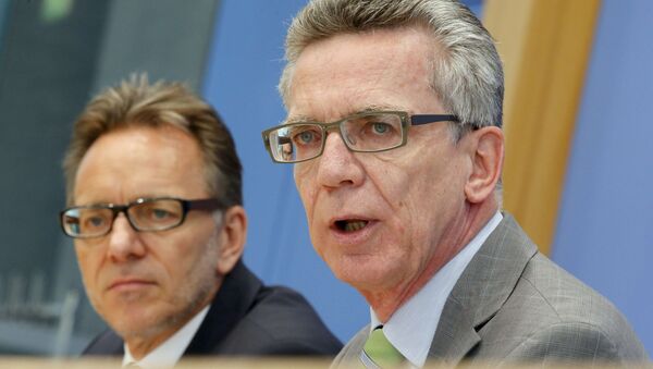 Holger Muench (L) Chief Commissioner of Germany's Bundeskriminalamt (BKA) Federal Crime Office and Interior Minister Thomas de Maiziere present the annual report on organized crime inGermany during a news conference in Berlin, Germany, October 6, 2015 - Sputnik International