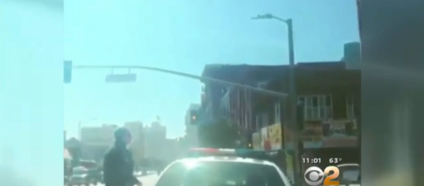 The video footage, posted on social media, begins with a Los Angeles police officer getting out of his patrol car, followed by a shot of a handgun held by a person watching the officer. The video footage, posted on social media, begins with a Los Angeles police officer getting out of his patrol car, followed by a shot of a handgun held by a person watching the officer. - Sputnik International