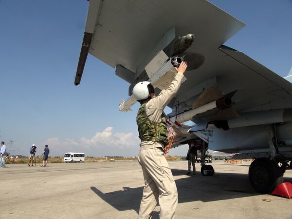 In this photo taken on Monday, Oct. 5, 2015, a Russian pilot fixes an air-to-air missile at his Su-30 jet fighter before a take off at Hmeimim airbase in Syria In this photo taken on Monday, Oct. 5, 2015, a Russian pilot fixes an air-to-air missile at his Su-30 jet fighter before a take off at Hmeimim airbase in Syria - Sputnik International