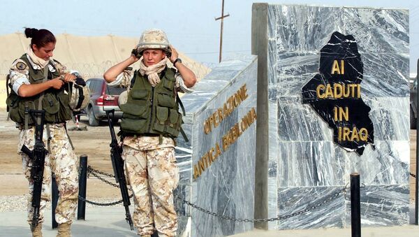 File photo of two Italian female soldiers wear their helmets as they pause next the monument in the memory of Nasiriyah's victims, at camp Mittica military base, in Nasiriyah, Iraq, Thursday, Nov. 11, 2004 - Sputnik International