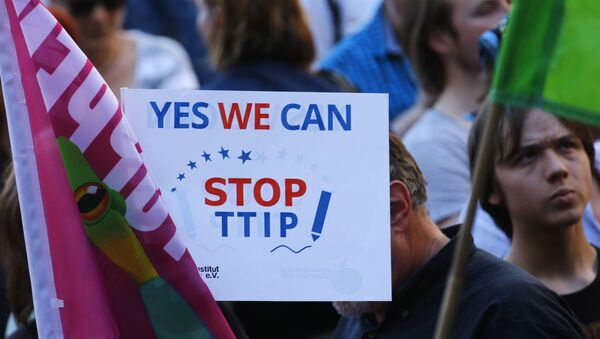 Demonstrators hold a sign against the TTIP contract during a protest against the upcoming G-7 in Munich, southern Germany, Thursday, June 4, 2015 - Sputnik International