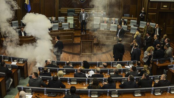 A white cloud of tear gas ascends after being released by opposition lawmakers in Kosovo's parliament in Pristina, on October 8, 2015 causing two MPs to faint, in protest at a recent EU-brokered deal reached by the government with Serbia - Sputnik International
