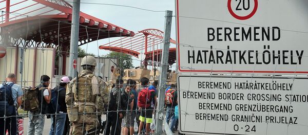 Hungarian soldiers standing guard are pictured from the Croatian side at the Croatian-Hungarian border crossing between the villages of Baranjsko Petrovo Selo, Croatia, and Beremend, Hungary, on September 22, 2015 Hungarian soldiers standing guard are pictured from the Croatian side at the Croatian-Hungarian border crossing between the villages of Baranjsko Petrovo Selo, Croatia, and Beremend, Hungary, on September 22, 2015 - Sputnik International