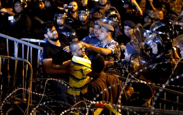 Lebanese protesters clash with riot police during a protest in Martyr square, Downtown Beirut, Lebanon October 8, 2015. Lebanese security forces fired a water cannon at scores of anti-government protesters on Thursday, Reuters witnesses said. The crowd chanted the people want the fall of the regime as riot police surrounded them in downtown Beirut. Lebanon has been hit by weeks of protests by people angry about political paralysis, corruption and poor infrastructure in the country. - Sputnik International