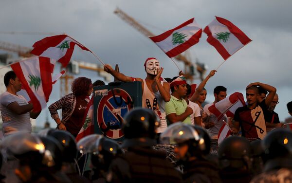 Protesters chant slogans as riot policemen block a street leading to the parliament building during a protest against perceived government failures, including a rubbish disposal crisis, in downtown Beirut, Lebanon October 8, 2015. - Sputnik International