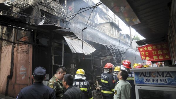 Firefighters try to extinguish a fire after an explosion at a restaurant in Wuhu, Anhui province, China, October 10, 2015 - Sputnik International