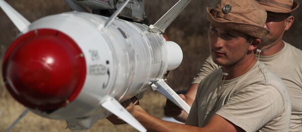 Russian servicemen attach a Kh-25 high-precision missile to a Su-24 aircraft at the Khmeimim airbase in Syria. Russian servicemen attach a Kh-25 high-precision missile to a Su-24 aircraft at the Khmeimim airbase in Syria. - Sputnik International