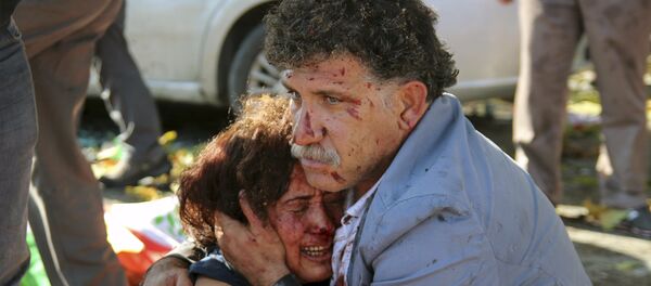An injured man hugs an injured woman after an explosion during a peace march in Ankara, Turkey, October 10, 2015 An injured man hugs an injured woman after an explosion during a peace march in Ankara, Turkey, October 10, 2015 - Sputnik International