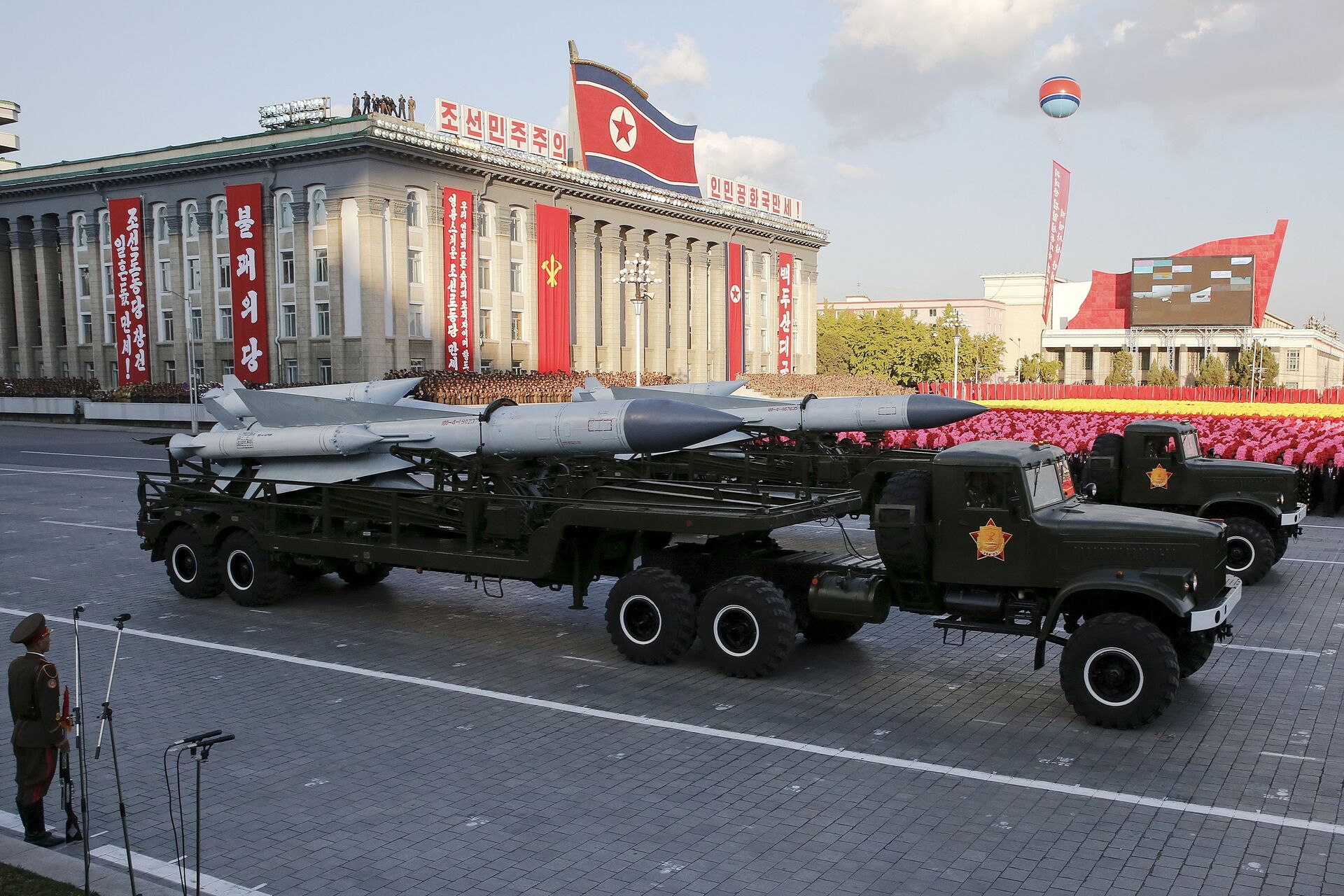 Missiles are taken on trucks past a stand with North Korean leader Kim Jong Un during the parade celebrating the 70th anniversary of the founding of the ruling Workers' Party of Korea, in Pyongyang October 10, 2015 - Sputnik International, 1920, 29.12.2021
