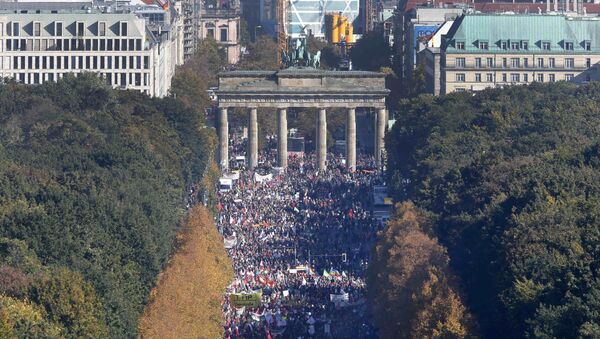 Consumer rights activists take part in a march to protest against the Transatlantic Trade and Investment Partnership (TTIP), mass husbandry and genetic engineering, in Berlin, Germany, October 10, 2015 - Sputnik International