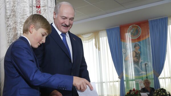 Belarusian President Alexander Lukashenko with his youngest son Nikolai casts his ballot at a polling station, during the presidential election, in Minsk, Belarus - Sputnik International