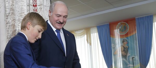 Belarusian President Alexander Lukashenko with his youngest son Nikolai casts his ballot at a polling station, during the presidential election, in Minsk, Belarus - Sputnik International
