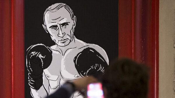 A man takes a picture of an artwork depicting Russian President Vladimir Putin as boxing legend Muhammad Ali during the Putin Universe exhibition in Moscow, Russia, Wednesday, Oct. 7, 2015 - Sputnik International