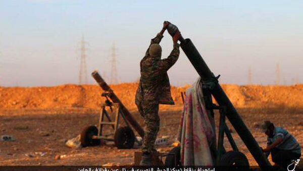 In this image posted on Thursday, Oct. 8, 2015, by the Rased News Network, a Facebook page affiliated with Islamic State, shows Islamic State militants preparing to fire a mortar to shell towards Syrian government forces positions at Tal Arn in Aleppo province, Syria - Sputnik International