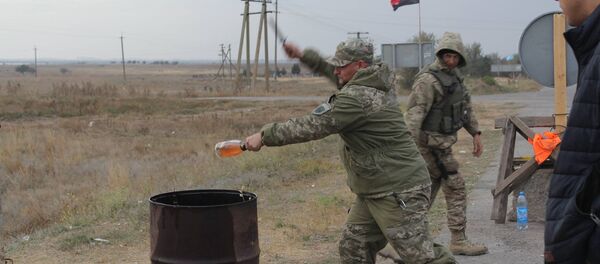 Right Sector activist smashes a bottle of expensive alcohol over a barrel. Right Sector activist smashes a bottle of expensive alcohol over a barrel. - Sputnik International