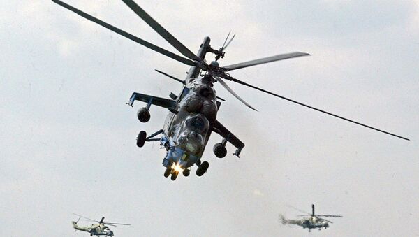 File Photo: Mi-24 helicopter gunships of Berkuty (Golden Eagles) Russian aerobatic team perform during the Flying Legend. - Sputnik International