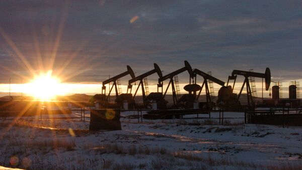 In this Jan. 14, 2015 file photo, some of the 60 rigs that are drilling surrounding McKenzie County, 40 percent of the rigs statewide, work in western North Dakota - Sputnik International