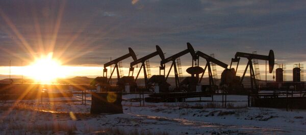 In this Jan. 14, 2015 file photo, some of the 60 rigs that are drilling surrounding McKenzie County, 40 percent of the rigs statewide, work in western North Dakota - Sputnik International