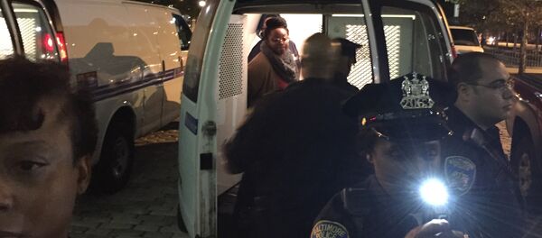 Protesters are placed into a van by police early Thursday, Oct. 15, 2015, in Baltimore - Sputnik International