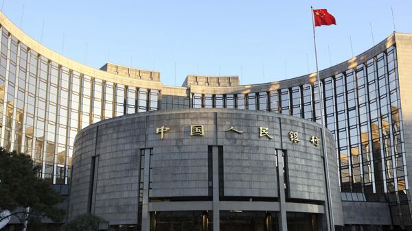 In this Nov. 27, 2008, file photo released by China's Xinhua News Agency, a Chinese flag flutters in front of the headquarters of the People's Bank of China (PBOC) in Beijing - Sputnik International