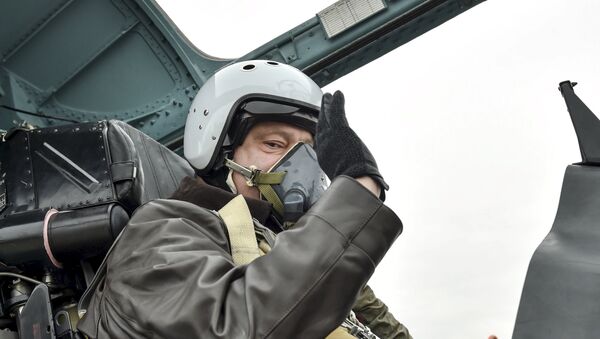 Ukrainian President Petro Poroshenko waves as he takes part in a testing flight onboard a Sukhoi Su-27 fighter aircraft during his working trip to Zaporizhia region on the Day of Defender of Ukraine, October 14, 2015 - Sputnik International
