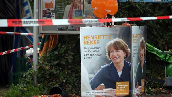 Election posters of independent candidate for the mayor of Cologne Henriette Reker stand behind a police barrier in Cologne, Germany, Saturday, Oct. 17, 2015. - Sputnik International