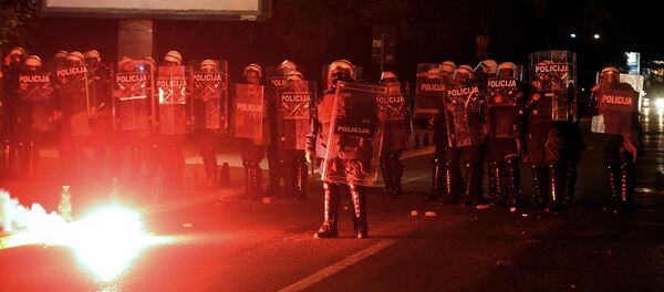 Demonstrators throwing torches at Montenegrin police officers during anti-government protest in Podgorica, Montenegro, Sunday, Oct. 18, 2015. - Sputnik International