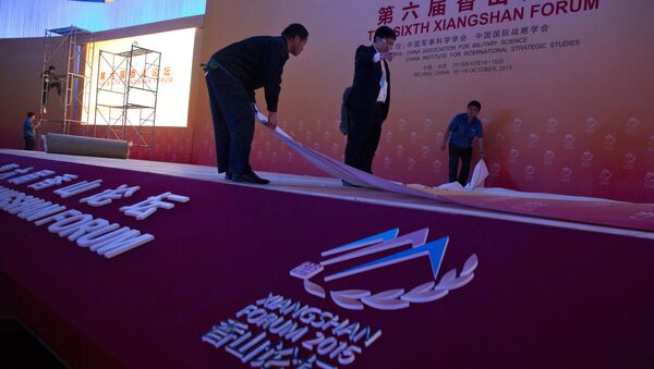 Workers set up the stage before the welcome banquet of the 6th Xiangshan Forum at which analysts, military leaders and others from around the globe will discuss Asian-Pacific security, maritime issues and anti-terrorism in Beijing, Friday, Oct. 16, 2015. - Sputnik International