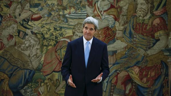 US Secretary of State John Kerry gestures in front of a tapestry while waiting for Spanish King Felipe before their meeting at the Zarzuela Palace in Madrid, Spain, October 19, 2015. - Sputnik International