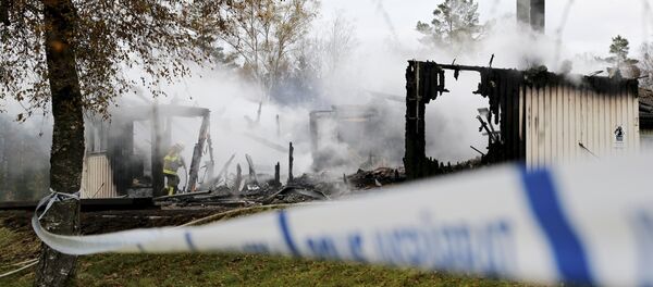 A firefighter works to extinguish a fire that broke out early in the morning at an accommodation for asylum seekers, near Munkedal in Sweden October 20, 2015 A firefighter works to extinguish a fire that broke out early in the morning at an accommodation for asylum seekers, near Munkedal in Sweden October 20, 2015 - Sputnik International