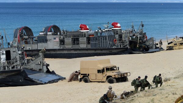 US marines push a Humvee stuck on the sand as they disembark from the overcrafts deploid by the USS Arlington amphibious transport dock during the NATO's Trident Juncture exercise at Pinheiro da Cruz beach, south of Lisbon, near Grandola on October 20, 2015 - Sputnik International