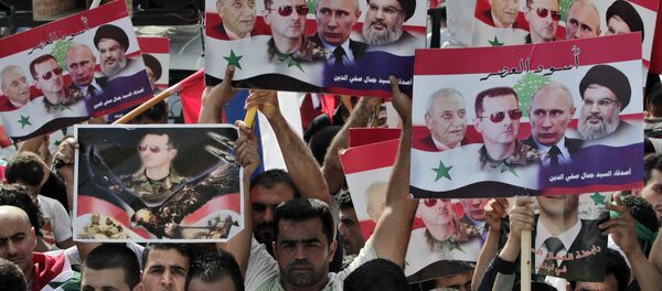 Syrians who lives in Lebanon hold posters with photos of Syrian President Bashar Assad, Russian President Vladimir Putin, Hezbollah leader Sheikh Hassan Nasrallah, and Lebanese Parliament Speaker Nabih Berri, with Arabic that reads Lions of the time, during a rally to thank Moscow for its intervention in Syria, in front of the Russian embassy in Beirut, Lebanon, Sunday, Oct. 18, 2015 Syrians who lives in Lebanon hold posters with photos of Syrian President Bashar Assad, Russian President Vladimir Putin, Hezbollah leader Sheikh Hassan Nasrallah, and Lebanese Parliament Speaker Nabih Berri, with Arabic that reads Lions of the time, during a rally to thank Moscow for its intervention in Syria, in front of the Russian embassy in Beirut, Lebanon, Sunday, Oct. 18, 2015 - Sputnik International