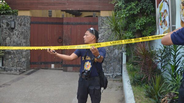 Police mark the crime scene with a yellow tape where two Chinese diplomats were killed in Cebu province, central Philippines on Wednesday Oct. 21, 2015 - Sputnik International