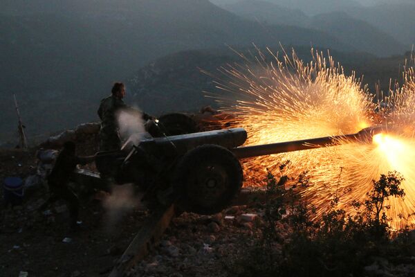 In this photo taken on Saturday, Oct. 10, 2015, Syrian army personnel fire a cannon in Latakia province, about 12 from the border with Turkey in Syria In this photo taken on Saturday, Oct. 10, 2015, Syrian army personnel fire a cannon in Latakia province, about 12 from the border with Turkey in Syria - Sputnik International