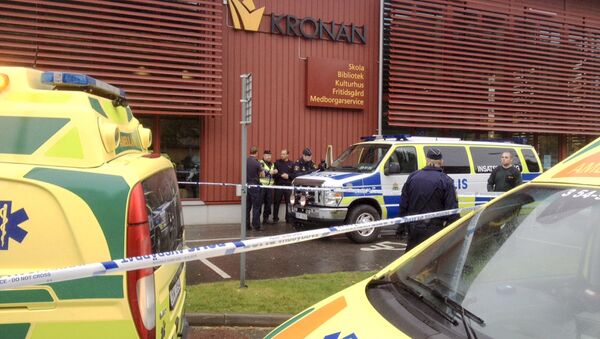 Police cordon off an area after a masked man attacked people with a sword at a school in Trollhattan, western Sweden October 22, 2015 - Sputnik International