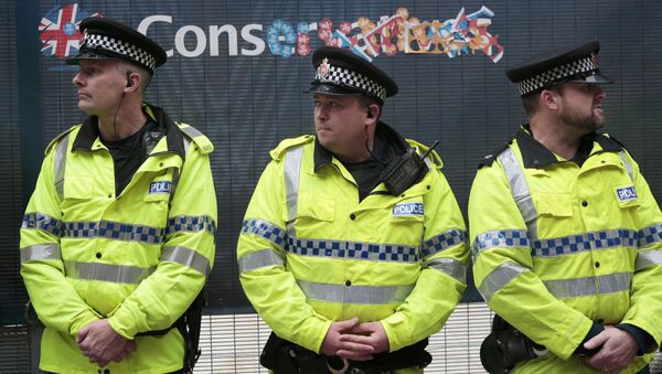 Police stand guard near a defaced sign during a demonstration outside the Conservative Party Conference in Manchester, Britain October 6, 2015. - Sputnik International
