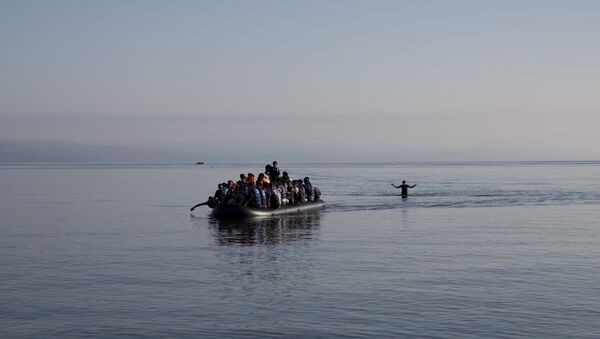 Afghan migrants arrive on the shores of the Greek island of Lesbos after crossing the Aegean sea from Turkey on a inflatable dinghy, Sunday Sept. 27, 2015 - Sputnik International