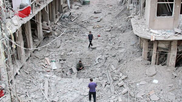 People walking on the rubble of damaged buildings in Darayya, southwest of the capital Damascus - Sputnik International
