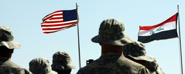 US troops stand to attention in front of American and Iraqi (R) flags during a handover ceremony near the northern Iraqi town of Hawija US troops stand to attention in front of American and Iraqi (R) flags during a handover ceremony near the northern Iraqi town of Hawija - Sputnik International
