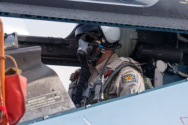 Pilot in the cockpit of a Russian Su-30SM Flanker-H multirole fighter deployed at Hmeymim air base near Latakia, Syria, all set for take-off. - Sputnik International