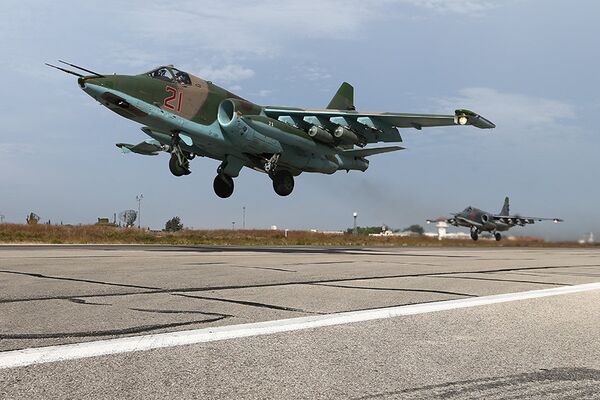 Russian Su-25SM Frogfoot-A heavy ground attack aircraft taking off at Hmeymim air base near Latakia, Syria. The aircraft is armed with OFAB-250-270 high-explosive fragmentation bombs (paired), BetAB-500 concrete-piercing bombs (attached near fuselage) and a GSh-30-2 dual-barrel automatic cannon (under cockpit). - Sputnik International