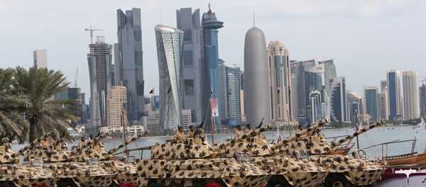 A general view show armoured vehicles rolling during the military parade marking the Gulf emirate's National Day celebrations in Doha on December 18, 2012 - Sputnik International