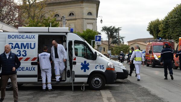 Rescuers are pictured on October 23, 2015 in Puisseguin, near Libourne, southwestern France, following a road accident in which at least 42 people, most of them elderly, were killed when a coach collided with a lorry and caught fire in southwest France, in the country's worst road accident for three decades, officials said - Sputnik International
