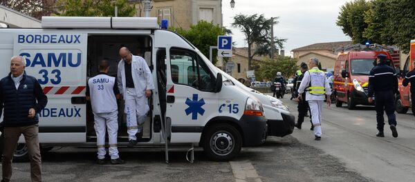 Rescuers are pictured on October 23, 2015 in Puisseguin, near Libourne, southwestern France, following a road accident in which at least 42 people, most of them elderly, were killed when a coach collided with a lorry and caught fire in southwest France, in the country's worst road accident for three decades, officials said - Sputnik International