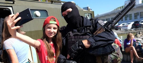 A girl poses for a selfie with a police officer during the 'Resort 2015. Kuban is a Safe Territory' project in the Krasnodar Territory A girl poses for a selfie with a police officer during the 'Resort 2015. Kuban is a Safe Territory' project in the Krasnodar Territory - Sputnik International