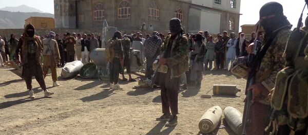 In this photograph taken on October 13, 2015, Afghan Taliban militants gather around parts of a US F-16 aircraft that was struck over in Sayid Karam district of eastern Paktia province - Sputnik International