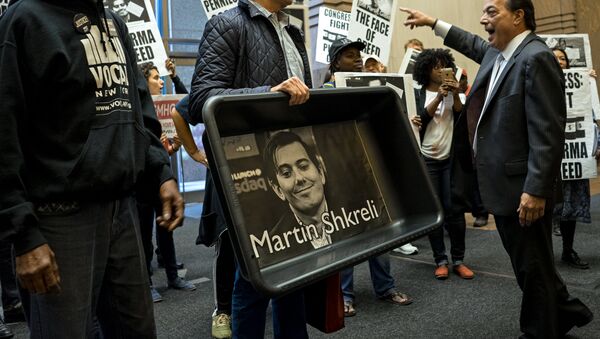 Carrying an image of Turing Pharmaceuticals CEO Martin Shkreli in a makeshift cat litter pan, AIDS activists and others are asked to leave the lobby of 1177 6th Ave. in New York, Thursday, Oct. 1, 2015, during a protest highlighting pharmaceutical drug pricing. - Sputnik International