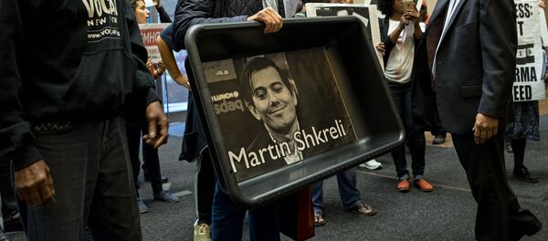 Carrying an image of Turing Pharmaceuticals CEO Martin Shkreli in a makeshift cat litter pan, AIDS activists and others are asked to leave the lobby of 1177 6th Ave. in New York, Thursday, Oct. 1, 2015, during a protest highlighting pharmaceutical drug pricing. Carrying an image of Turing Pharmaceuticals CEO Martin Shkreli in a makeshift cat litter pan, AIDS activists and others are asked to leave the lobby of 1177 6th Ave. in New York, Thursday, Oct. 1, 2015, during a protest highlighting pharmaceutical drug pricing. - Sputnik International